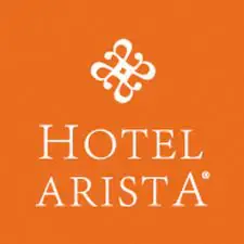 Logo of hotel arista featuring a white, stylized ornamental emblem above the words "hotel arista" in white capital letters, all set against a solid orange background.