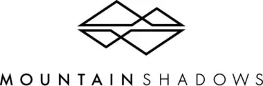 Logo for "mountain shadows" featuring a stylized graphic of two mountain peaks in a symmetrical, geometric design, positioned above the brand name in capitalized, sleek font.