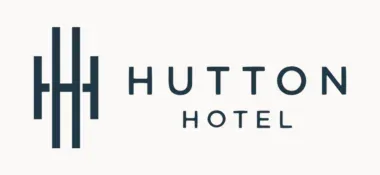 Logo of hutton hotel featuring three stylized vertical lines on the left that resemble a building, next to the words "hutton hotel" in uppercase sans-serif font.