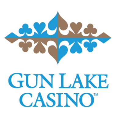 Logo of gun lake casino featuring a stylized arrangement of suit symbols from playing cards in black and gold above the blue text "gun lake casino".